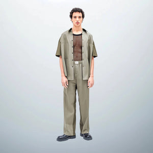 Model, 185 cm (6'0") tall, wearing size 38 TOMMAZO JOVE Pants Khaki, showcasing their sleek and comfortable design as part of the UNFOLLOWORLD collection. 