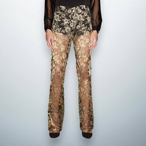 High-waisted gold lace trousers crafted from Dentelle de Calais fabric with intricate floral patterns, featuring integrated black silk-viscose underpants.