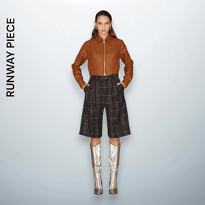 Model wearing mid-length plaid wool shorts with a structured silhouette, a signature runway piece from Unfolloworld’s CROSSROADS: From Paris to Limassol.

