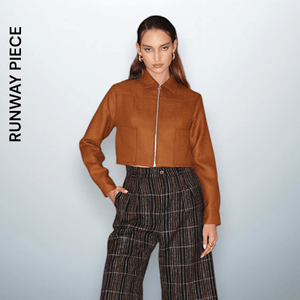 Model Christina, 180 cm, wearing a cropped camel-brown wool zip-up jacket with a sharp collar and front patch pockets. A signature piece from Unfolloworld’s debut runway show, CROSSROADS: From Paris to Limassol.